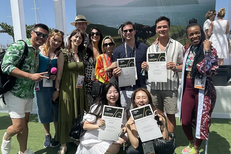 Team displaying certificates from Cannes Lions partnership